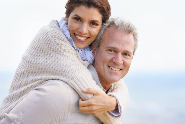 Happy and deeply in love. Portrait of a loving mature couple embracing and smiling happily - Photo, Image
