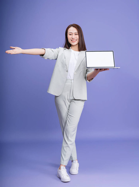 Photo of young Asian businesswoman on background - Φωτογραφία, εικόνα
