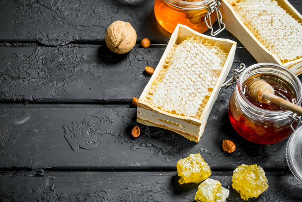 Different types of honey. On a black rustic background. - 写真・画像