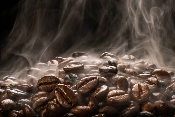 Coffee beans roasting with smoke,  selective focus, and soft focus. - 写真・画像