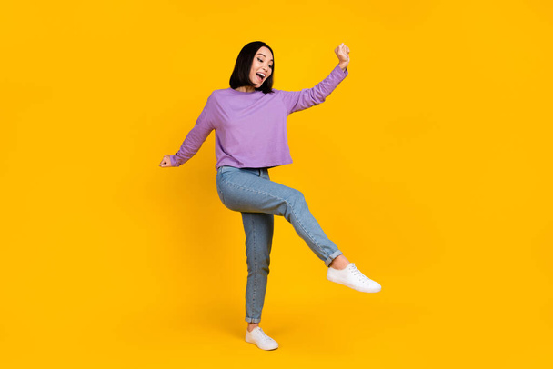 Full size photo of good mood optimistic girl bob hairdo violet shirt pants dancing having fun isolated on yellow color background. - Photo, image