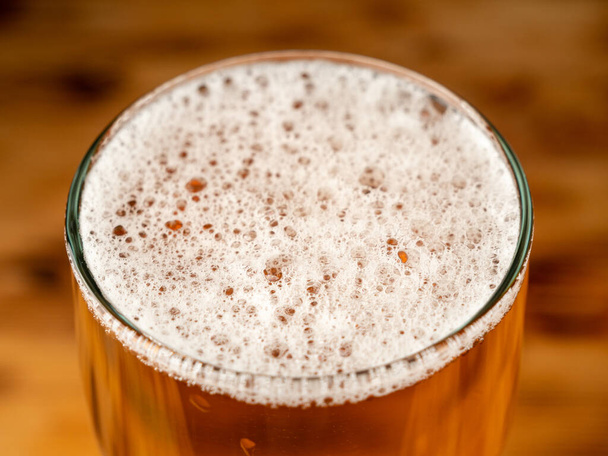 A glass of cold beer on a dark background. Glass of beer close-up. - Foto, imagen