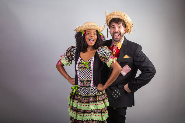 portrait, Brazilian couple in festa junina clothes. Saint John's festival. - 写真・画像