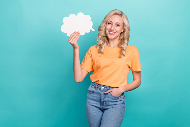 Photo of cheerful positive nice girl with wavy hairstyle yellow t-shirt arm in pocket hold mind cloud isolated on teal color background. - Fotografie, Obrázek