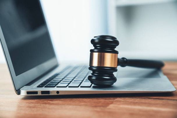 Closeup black wooden gavel hammer with laptop on desk in law firm or lawyer office background as justice and legal system for lawyer and judge, Symbolize authority and fairness in trials. equility - Foto, Imagem