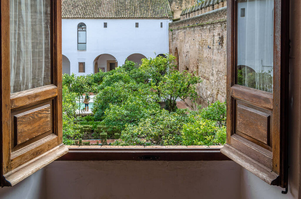 CORDOBA, SPAIN - FEBRUARY 16, 2014: View of The courtyard of the Moriscos (also known as the Mudejar Courtyard) located inside the Alcazar de los Reyes Cristianos, a medieval fortress in Cordoba, Andalusia, southern Spain - Фото, зображення
