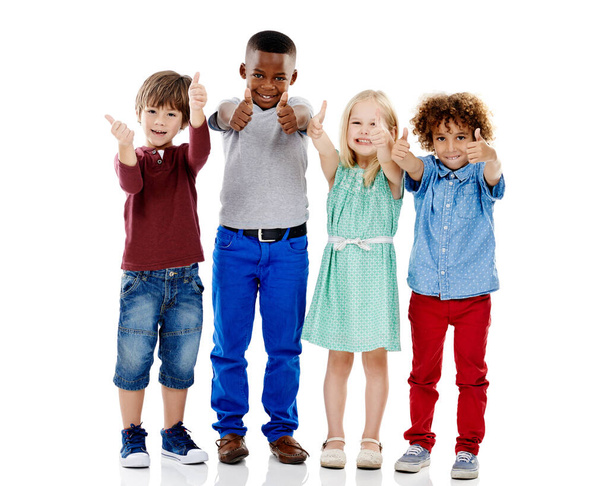 Дети, группа и вместе для больших пальцев на студийном портрете с улыбкой, соглашением и белым фоном. Девушка, мальчик или изолированные друзья для счастья, рука как или солидарность для детей с разнообразием. - Фото, изображение