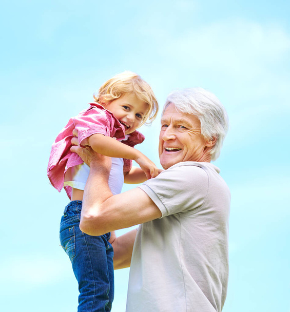 Happy, lifting and portrait of grandfather and grandson for bonding, affectionate and free time. Happiness, fun and playing with old man and young boy for family, generations and blue sky mockup. - Foto, Imagem