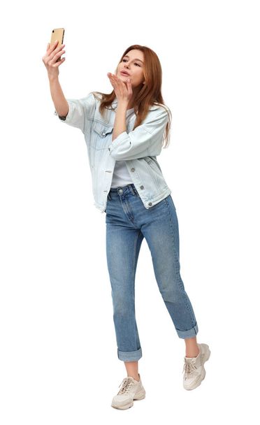 Beautiful woman taking selfie on white background - Фото, изображение