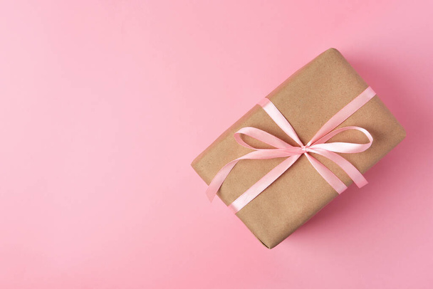Beautiful gift box with bow on pink background, top view. Space for text - Photo, Image