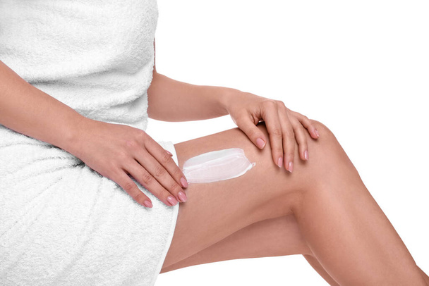 Woman with smear of body cream on her leg against white background, closeup - Фото, зображення