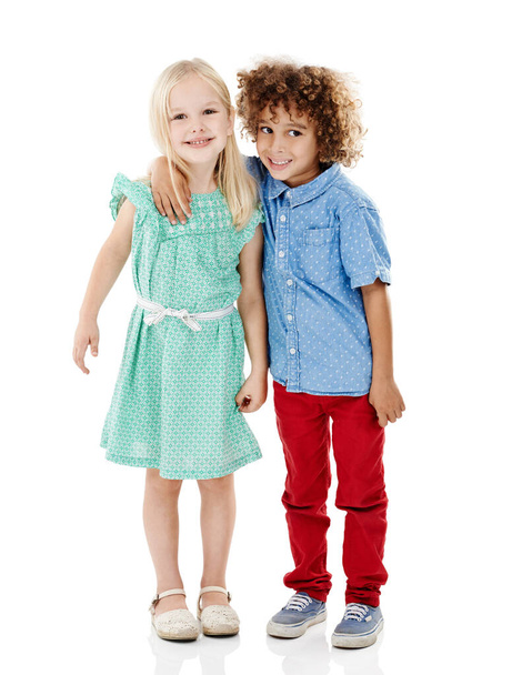 Theyre all about the cuteness. Studio shot of a cute little boy and girl posing together against a white background - Photo, Image