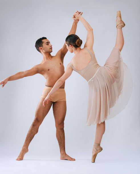 .Ballet dancing couple, studio and holding hands for balance, finesse and art movement for beauty in class. Young dancer team, performance or man with woman in class for fitness, teamwork and focus - Photo, image