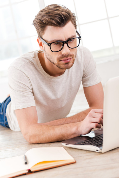 Thoughtful man working on laptop - Photo, Image