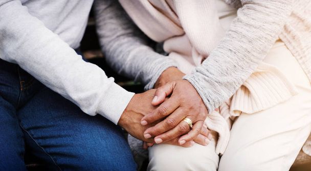 Holding hands, senior couple and support while together for empathy, love and care in marriage. Closeup of elderly man and woman with hope, respect and communication or kindness outdoor in retirement. - Photo, image