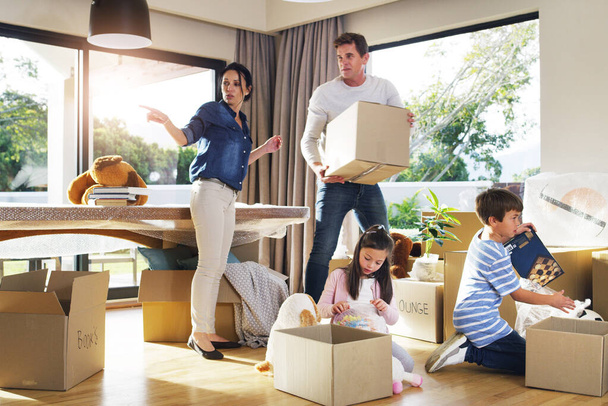 Moving, box and help with family in new house for property, investment and renting. Future, teamwork and real estate with parents and children in living room of home for relocation and homeowner. - Photo, Image