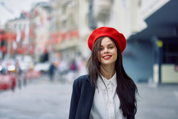 Happiness woman jumps and runs, follow me walks walks in the city against the backdrop of office buildings, stylish fashionable vintage clothes and make-up, spring walk, travel. High quality photo - Photo, Image