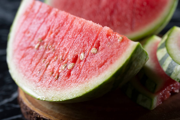 A closeup view of a large slice of watermelon. - Photo, image