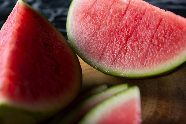 A closeup view of a large slice of watermelon. - Fotoğraf, Görsel