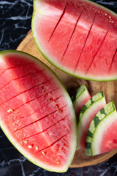 A top down view of slices and portions of a watermelon. - Φωτογραφία, εικόνα