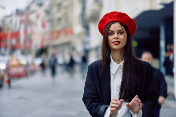 Happiness woman jumps and runs, follow me walks walks in the city against the backdrop of office buildings, stylish fashionable vintage clothes and make-up, spring walk, travel. High quality photo - Photo, Image