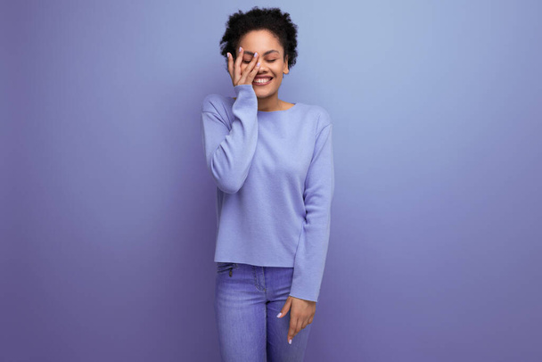 charming young 20s woman with afro hair gathered in a bun model appearance on the background with copy space. - Foto, Imagem