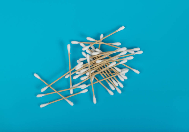 Cotton Swabs, Eco Natural Paper Ear Sticks, Biodegradable Hygiene Bud, Earwax Cleaner Swab, Ear Sticks on Blue Background - Photo, Image