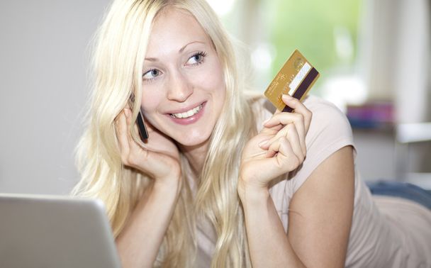 Young woman holds credit card - Φωτογραφία, εικόνα