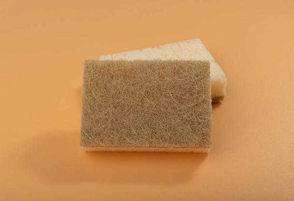 Natural Sponge, Eco Brown Sponges, Eco Friendly Hygiene Accessory, Scotch Brite Dishwasher on Yellow Background - Foto, afbeelding