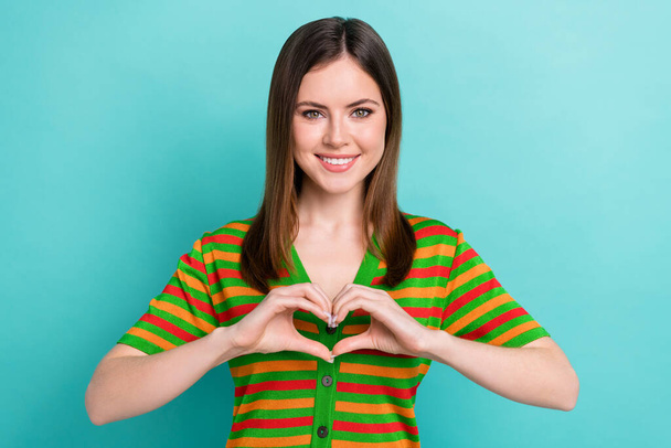 Photo of pretty shiny lady wear striped cardigan showing arms heart isolated turquoise color background. - Φωτογραφία, εικόνα