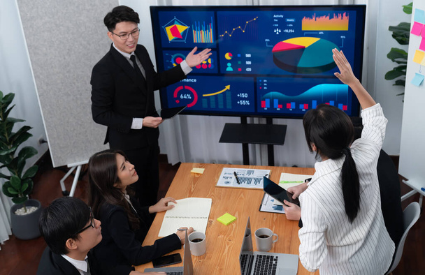 Confidence and asian businessman give presentation on financial analyzed by business intelligence in dashboard report to other people in board room meeting to promote harmony in workplace. - Foto, Imagen