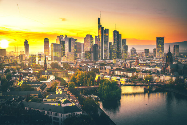 Frankfuert is the only skyline in Germany. backlit photography for sunset with a great sky and lighting in the houses. High-rise buildings, city recording and finance - Foto, imagen