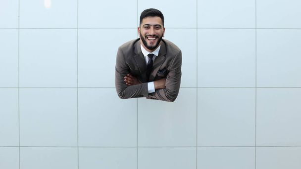Handsome smiling business man in a suit standing with his arms crossed. View from above - Fotoğraf, Görsel