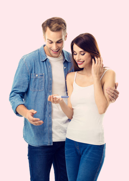 Young amorous happy couple, finding out results of a pregnancy test. Caucasian models - in love, relationship, dating, happy lovers, family concept. - Foto, afbeelding