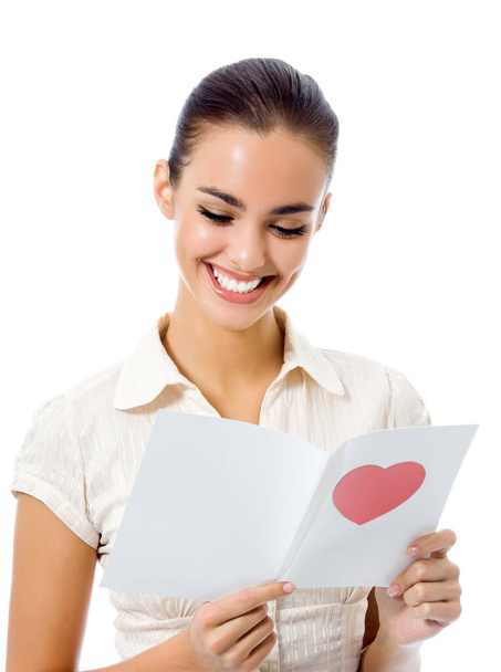 Young happy woman reading valentine card, isolated over white background - Photo, Image