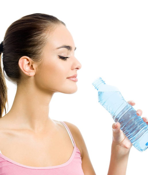 Young happy smiling woman in sportswear drinking water, isolated over white background - Foto, immagini