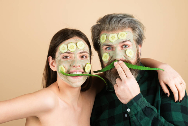 Couple with cucumbers mask and aloe. Girl with facial skincare fresh clean skin and beauty concept. Pair freshness - 写真・画像