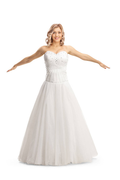 Beautiful bride in a gown spreading arms isolated on white background - Valokuva, kuva