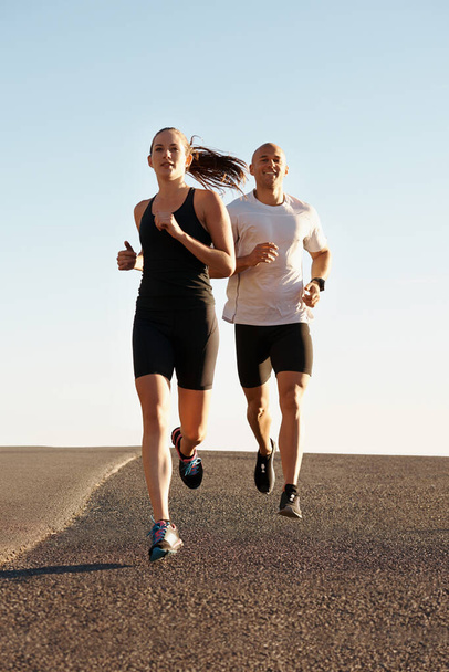 Morning, marathon and coach training woman as workout, run or morning exercise for health and wellness together. Sport, fitness and man runner running with athlete in a city for sports or energy. - Foto, imagen