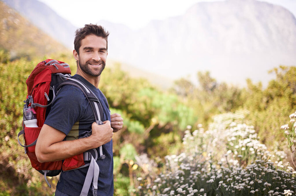 Hiking, happy and portrait of man on mountain for fitness, adventure and travel journey. Backpacking, summer and workout with male hiker trekking in nature path for training, freedom and explore. - Fotoğraf, Görsel