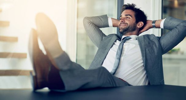 Rest, confidence and businessman with hands behind his head after finished project in the office. Relax, calm and happy professional male employee on a break with a success task in the workplace - Photo, Image