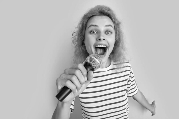 cheerful karaoke woman singer isolated on yellow background. young singer woman sing in karaoke studio. woman karaoke singer with microphone. - Fotografie, Obrázek