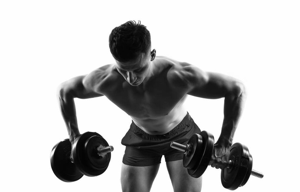 gym training of biceps and triceps in weightlifting sport. sportsman with gym dumbbell do weightlifting sport. weightlifting sport in gym. sportsman do weightlifting in sport gym isolated on white. - Foto, Imagem