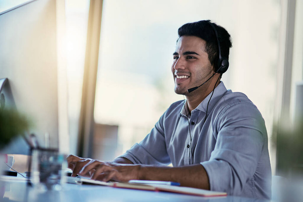 Customer support agent, smile and man in office consulting with advice, crm and happiness at work. Happy phone call, conversation and telecom help desk consultant speaking into headset at computer - Φωτογραφία, εικόνα