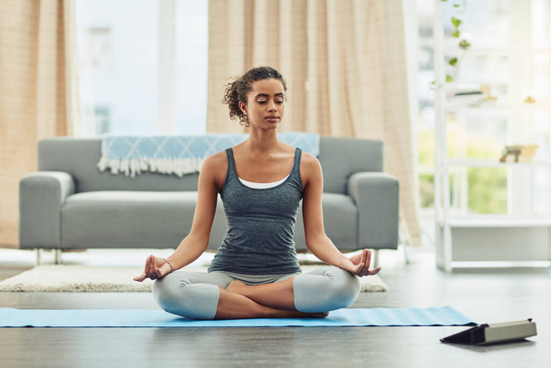 Tablet, meditation or woman with fitness, home and training for wellness, balance and exercise in the living room. Female person, technology or girl with online practice, yoga class or workout lesson. - Photo, image
