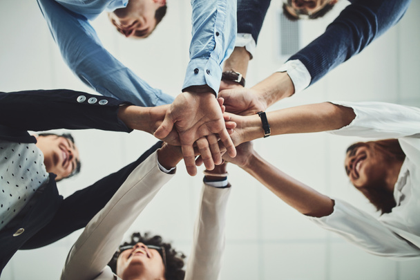Hands together, business people and solidarity with low angle, support and team huddle with collaboration. Group of employees working in office, teamwork and mission with workforce and hand stack. - Fotografie, Obrázek