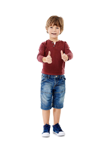 I believe in you. Studio shot of a cute little boy giving you thumbs up against a white background - Foto, Imagen