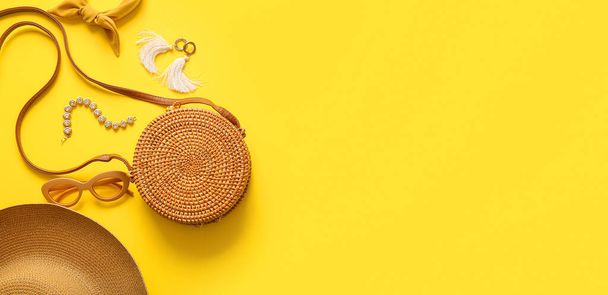 Stylish bag and accessories on yellow background with space for text - Photo, image