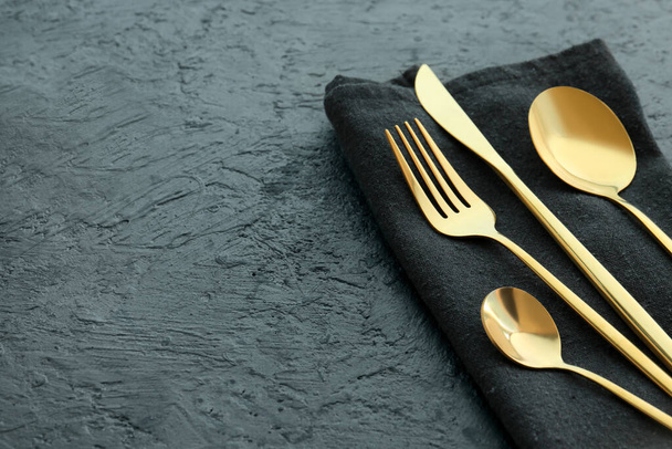 Golden cutlery on black background - Φωτογραφία, εικόνα