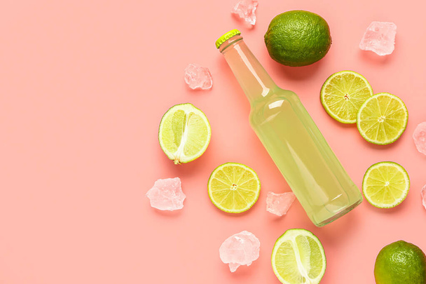 Composition with bottle of fresh soda and lime on pink background - Foto, Imagem